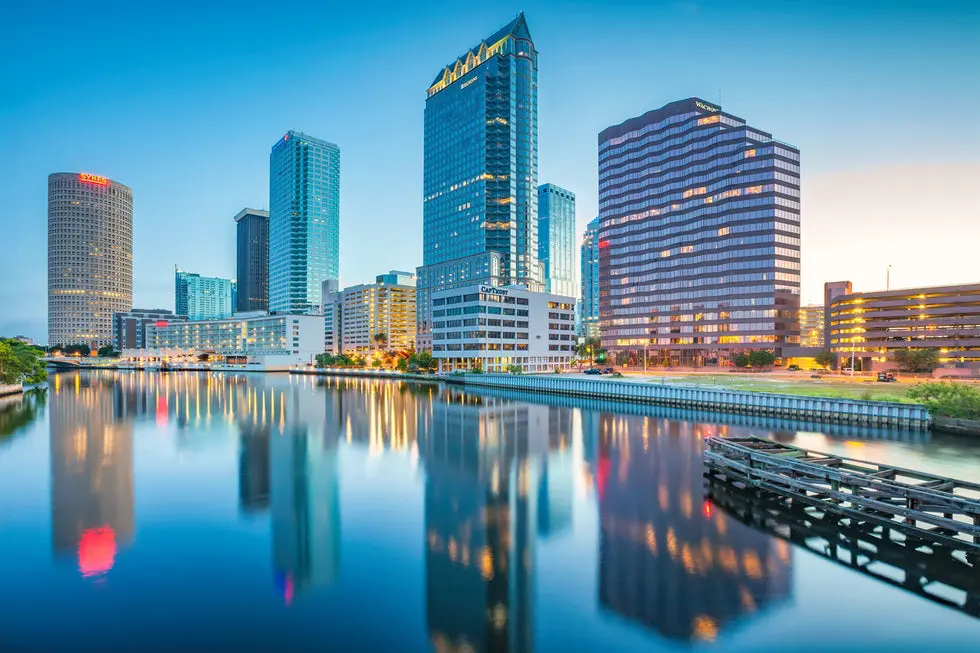 A city skyline with buildings and water.